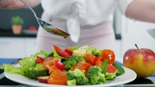 Preparing a Healthy Salad with Fresh Vegetables