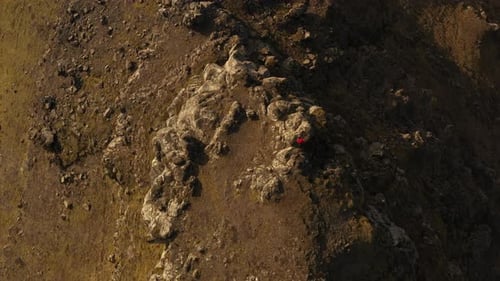 Drone Flight Over Man Standing In Rocky Landscape
