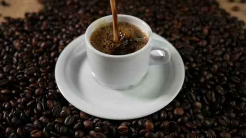Dark Roasted Coffee Being Poured Into Cup