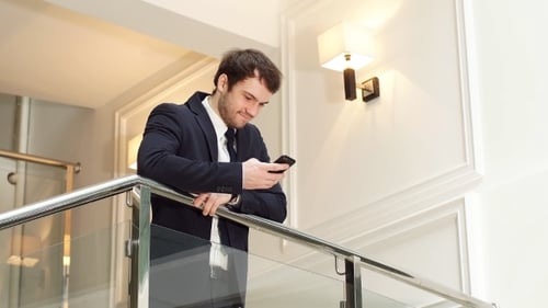 Handsome Businessman Using Smartphone in The Office.
