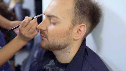 El maquillador pinta la barba del hombre