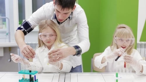 Children Doing Science Experiment with a Lab Assistant