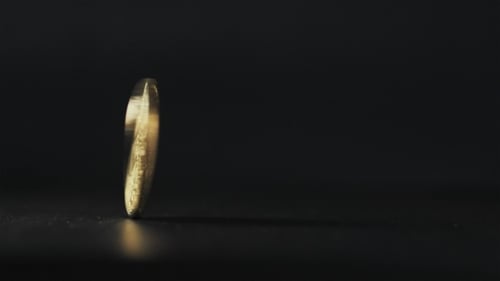 Gold Bitcoin Coin Stacked Against a Dark Background