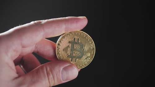 Hand Holding Gold Bitcoin Crypto Currency
