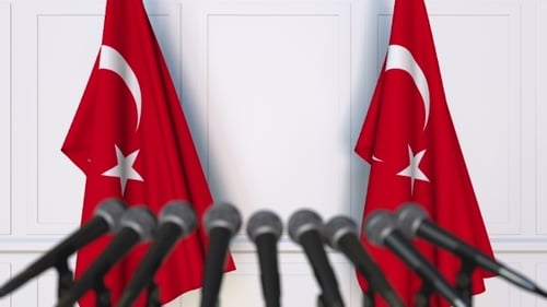 Waving Turkish Flags and Microphones for Corporate Announcements