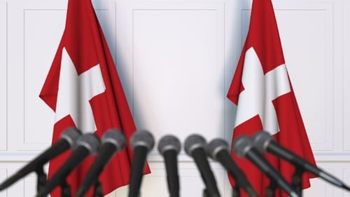 Swiss Flags and Microphones in Professional Corporate Event Setting