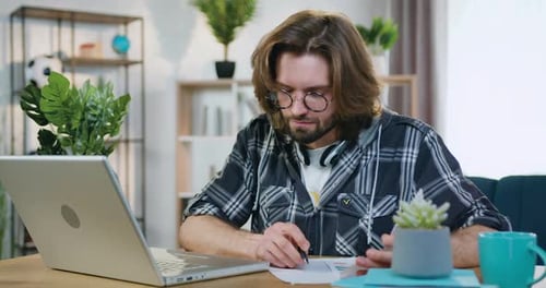 Man Works at Laptop at Home in Daytime