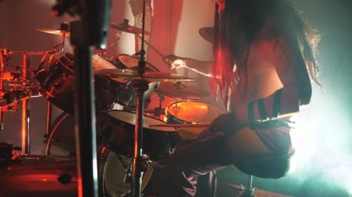 Unrecognizable Professional Drummer Playing on the Drum By Wooden Sticks During Rock Concert. Music