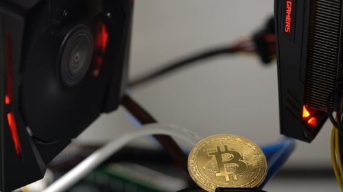 Bitcoin on the Background of a Graphics Card in a Rack for Crypto-currency Mining