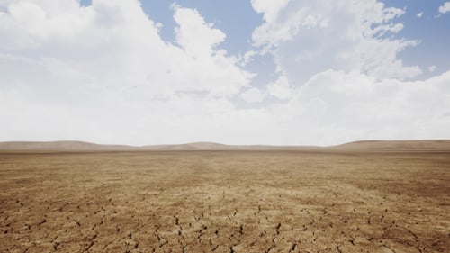 Vast Arid Desert Floor with Cracked Earth and Clouds