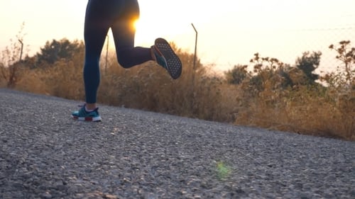 Follow To Feet of Young Girl Running at Country Road