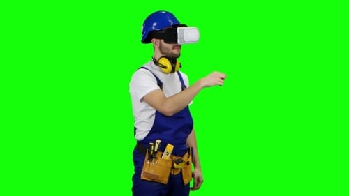 Engineer in Virtual Reality Glasses Builds Graphics in a Fictional Table on Green Screen