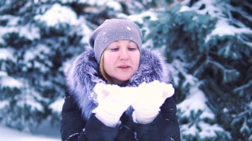 Girl Blowing Snow From Her Hands in the Winter Park, Shooting, Winter Landscape