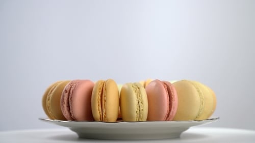 Colorful Macarons Rotating on a Silver Plate