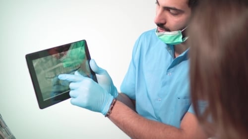 Doctor Shows Teeth X-ray on Tablet
