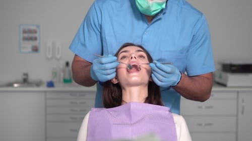 Dentist Examines Patient's Teeth