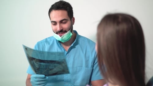 Dentist Explaining Dental X-Ray to Patient