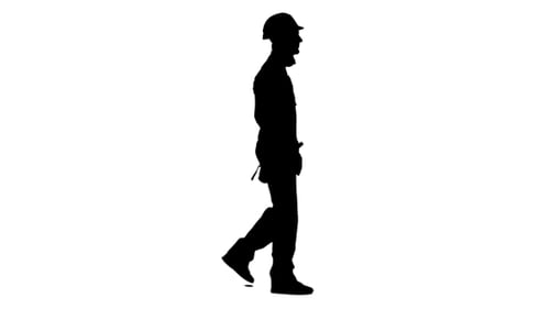 Silhouette of Construction Worker Walking with Power Drill