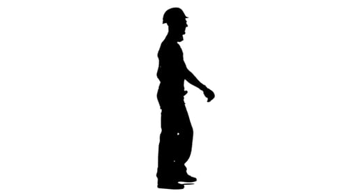 Silhouette of Construction Worker Walking Across Screen