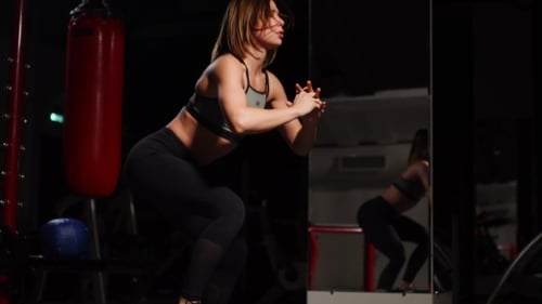 Woman Doing Step Aerobics in a Gym