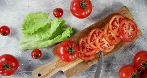 Tomatoes and Lettuce on a Cutting Board