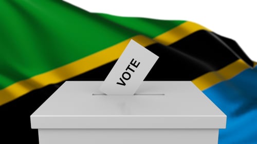 Tanzanian Flag Waving Behind Ballot Box with Vote Cards