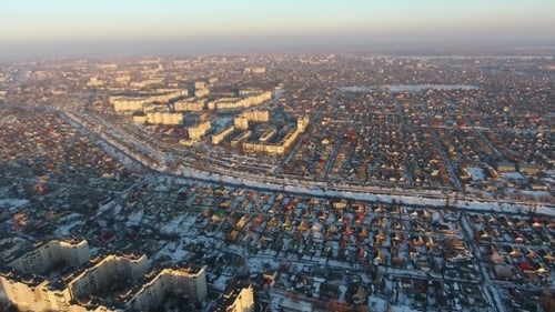Aerial View of Snow-Dusted City in Winter Sunlight