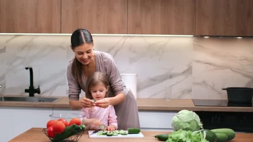 Woman and Child Preparing a Salad in Kitchen