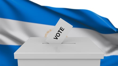 Vote Casting in Ballot Box with Waving Flag Background