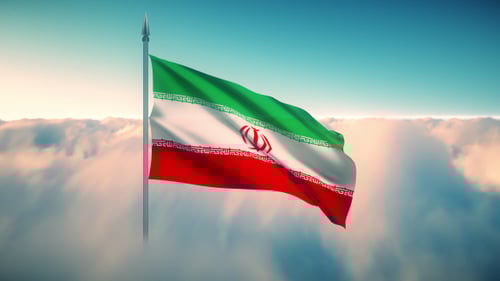 Waving Iranian Flag Above Clouds In Blue Sky