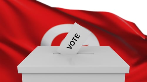 Tunisia Flag Background with Voting Ballots Dropping into Ballot Box