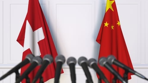 Flags of Switzerland and China at International Press Conference