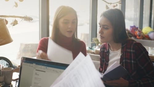 Two Women Discussing Business in a Bright Office