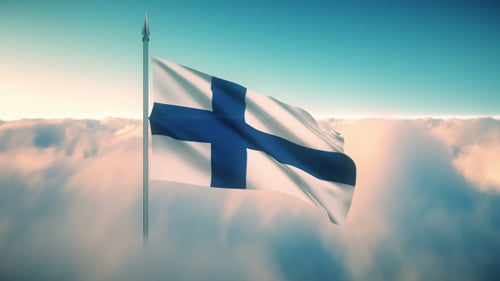 Waving Finland Flag over Clouds with Blue Sky Background