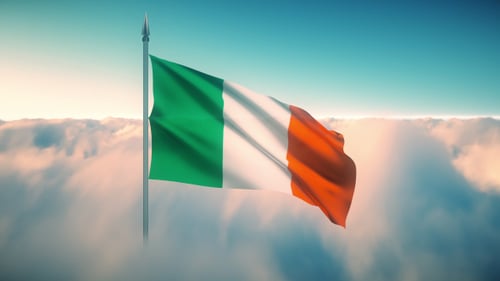Waving Irish Flag Against Cloudy Sky