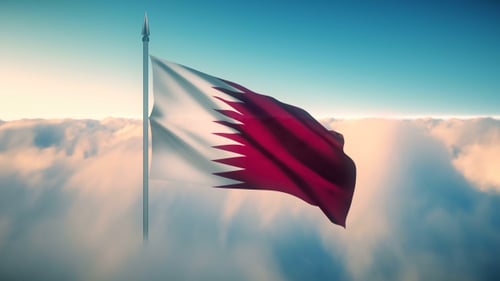 Qatar National Flag Waving in Blue Sky with Clouds
