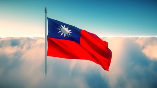 Taiwan Flag Waving Above Clouds in Clear Blue Sky