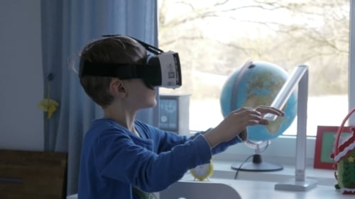 Boy Using Virtual Reality Headset in Bedroom