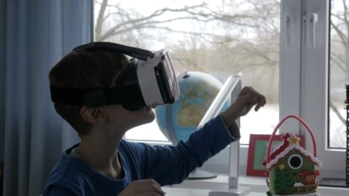 Boy Uses VR Headset at Home
