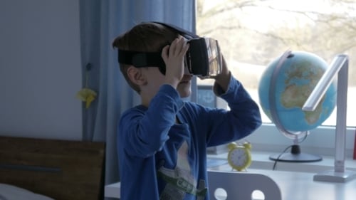Boy Uses VR Headset in Bedroom