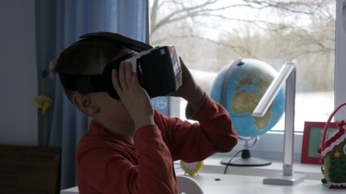 Boy Using Virtual Reality Headset in Bedroom