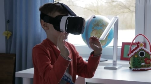 Boy Wearing VR Headset Interacting with Digital World