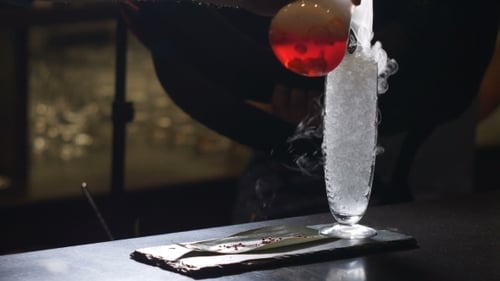 Professional Bartender Preparing a Cocktail with Ice a Mix of Alcohol in a Nightclub or Pub