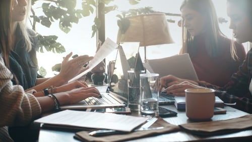 Female Colleagues Working in Cafe During Lunch