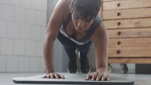 Young Fit and Tone Up Woman Doing Fitness Workout with Plank Elements for Strenght Abs in Sunny Loft