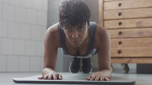 Young Fit and Tone Up Woman Doing Fitness Workout with Plank Elements for Strenght Abs in Sunny Loft