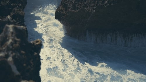 Powerful Waves and Sea Foam in Rocks