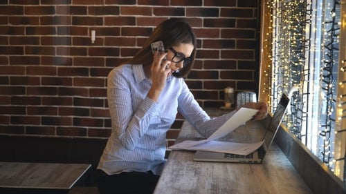 Business Woman Works With Laptop and Phone