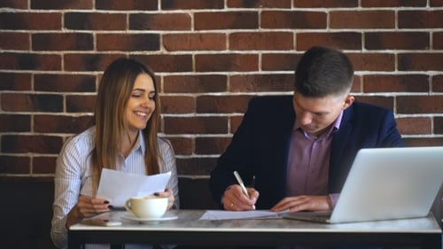 Colleagues Working Together in a Cafe at the Computer