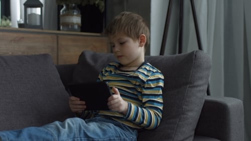 Young Boy Using Tablet Computer at Home